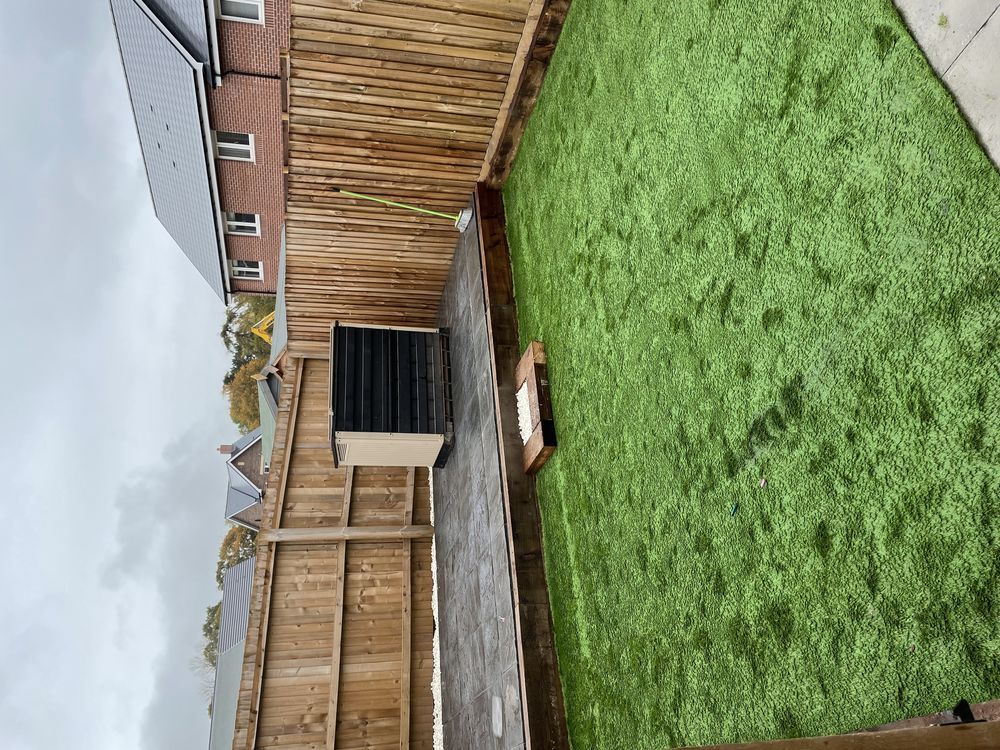 Timber fencing and gate around a lawn and garden shed