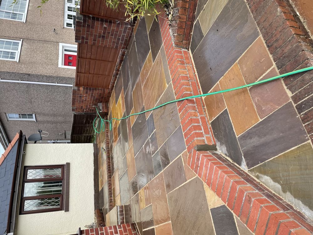 Stone paving and brick edging beside a house
